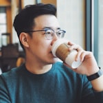 Image of man with glasses drinking coffee